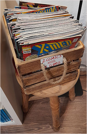 English comic books are placed in a wooden basket and you get 2 for 3 euros